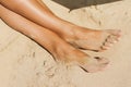 Beautiful slim woman legs on the beach Royalty Free Stock Photo