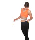 Beautiful slim woman measuring her waistline with a measuring tape Royalty Free Stock Photo