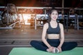 Beautiful slim young woman resting at gym.