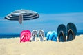 Beautiful slippers in the sand of the sea in Greece background Royalty Free Stock Photo