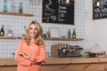 beautiful small business owner smiling at camera while standing