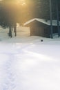 A beautiful small cabin on a shore of lake in central Norway. Snowy winter landscape. Royalty Free Stock Photo