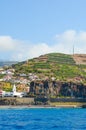 Beautiful small fisherman village Camara de Lobos in Madeira Island, Portugal photographed from the waters of the Atlantic ocean. Royalty Free Stock Photo