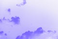 Beautiful small fluffy clouds on a sky background. Copy space. Purple violet toned