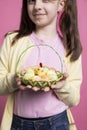 Beautiful small girl with bunny ears holding an egg basket for easter festivity Royalty Free Stock Photo