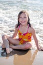 Beautiful little girl enjoying a sunny day on the beach Royalty Free Stock Photo