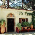 Beautiful small greek chapel with flower pots (Crete, Greece) Royalty Free Stock Photo