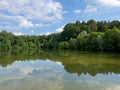A beautiful small lake in the countryside. Sunny day with clouds in the sky. Royalty Free Stock Photo
