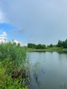 A beautiful small lake in the countryside. Sunny day with clouds in the sky. Royalty Free Stock Photo