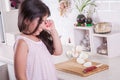 Beautiful small middle eastern girl crying in kitchen, tears of onion. studio shot.