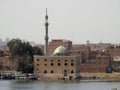 a beautiful small mosque with a green dome and tall minaret on the river Nile bank, A mosque masjid