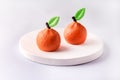 Beautiful Small Mousse Cake in Shape of Citrus Mandarin Tasty Modern Dessert Pastry White Blue Background