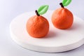 Beautiful Small Mousse Cake in Shape of Citrus Mandarin Tasty Modern Dessert Pastry White Blue Background