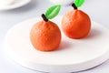 Beautiful Small Mousse Cake in Shape of Citrus Mandarin Tasty Modern Dessert Pastry White Blue Background Toned
