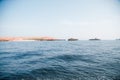 Beautiful small rocky islands in the middle of the sea under the clear blue sky Royalty Free Stock Photo