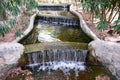 Beautiful small waterfall with cascades in Reina Sofia Park, Guardamar del Segura. Valencia, Spain. Royalty Free Stock Photo