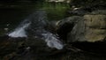 Beautiful small waterfall and giant stones. Creative. Cold mountainous river of a wild lake. Royalty Free Stock Photo