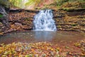 Beautiful small waterfall on a mountain stream. Beautiful autumn landscape Royalty Free Stock Photo