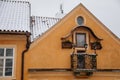 Beautiful small yellow traditional balcony with flower pots and religious icon on facade, View from Charles Bridge, Baroque