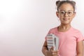 Beautiful smart schoolgirl is holding a pile of books Royalty Free Stock Photo