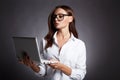 Beautiful smart young business woman in glasses, with laptop
