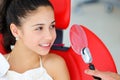 Beautiful smile with white teeth. A dentist examines the oral cavity of a young beautiful girl