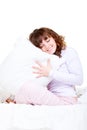 Beautiful smiley woman with pillow