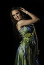 Beautiful smiliing brunette woman in green couture evening wear