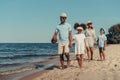 beautiful smiling african american family with rugby ball walking together