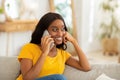 Beautiful smiling African American woman making phone call indoors, copy space Royalty Free Stock Photo