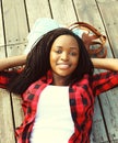 Beautiful smiling african woman relaxed on wooden floor Royalty Free Stock Photo