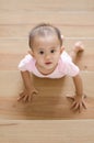 Beautiful smiling asian baby girl while crawling up a stair.