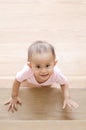 Beautiful smiling asian baby girl while crawling up a stair.