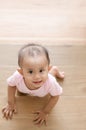 Beautiful smiling asian baby girl while crawling up a stair.
