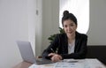 Beautiful smiling Asian businesswoman hand holding pen working using tablet at office. Looking at camera. Royalty Free Stock Photo