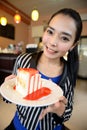 The beautiful smiling asian woman with a cake