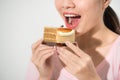 Beautiful smiling asian young woman with a chocolate cake isolated on white background Royalty Free Stock Photo