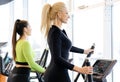 Athletic woman doing fitness cardio exercises in the gym. Two sporty women working out together Royalty Free Stock Photo