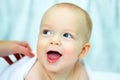 Beautiful smiling baby child after bath. Cute toddler on the bed under the blanket Royalty Free Stock Photo