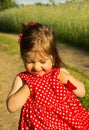 Beautiful smiling baby girl in red dress in summer day Royalty Free Stock Photo