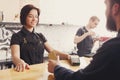 Smiling barista taking payment from client at cafe Royalty Free Stock Photo