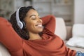 Beautiful Smiling Black Woman In Wireless Headphones Listening Music At Home Royalty Free Stock Photo