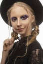 A beautiful smiling blond teenage girl wearing a black witch got Royalty Free Stock Photo