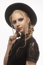 A beautiful smiling blond teenage girl wearing a black witch got Royalty Free Stock Photo