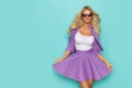 Beautiful Smiling Blond Woman In Sunglasses And Purple Costume Royalty Free Stock Photo