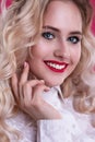 Beautiful smiling blonde with curls, red lips. Beautiful face.