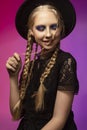 A beautiful smiling blonde teenage girl wearing a black gothic d Royalty Free Stock Photo