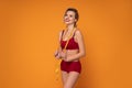 Beautiful, smiling, blonde woman in underwear measuring fit body after diet with a centimeter tape Royalty Free Stock Photo