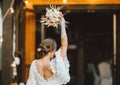 Beautiful smiling bride brunette young woman in white lace dress throwing wedding bouquet. Selective focus on flowers Royalty Free Stock Photo