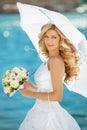 Beautiful smiling bride girl in wedding dress with white umbrell Royalty Free Stock Photo